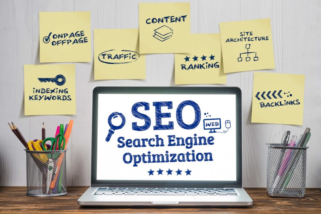 SEO Services in India displayed on a laptop screen with sticky notes highlighting key strategies like content, traffic, backlinks, and keyword optimization